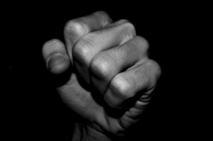 With a closed palm, we warn with our fist . . .